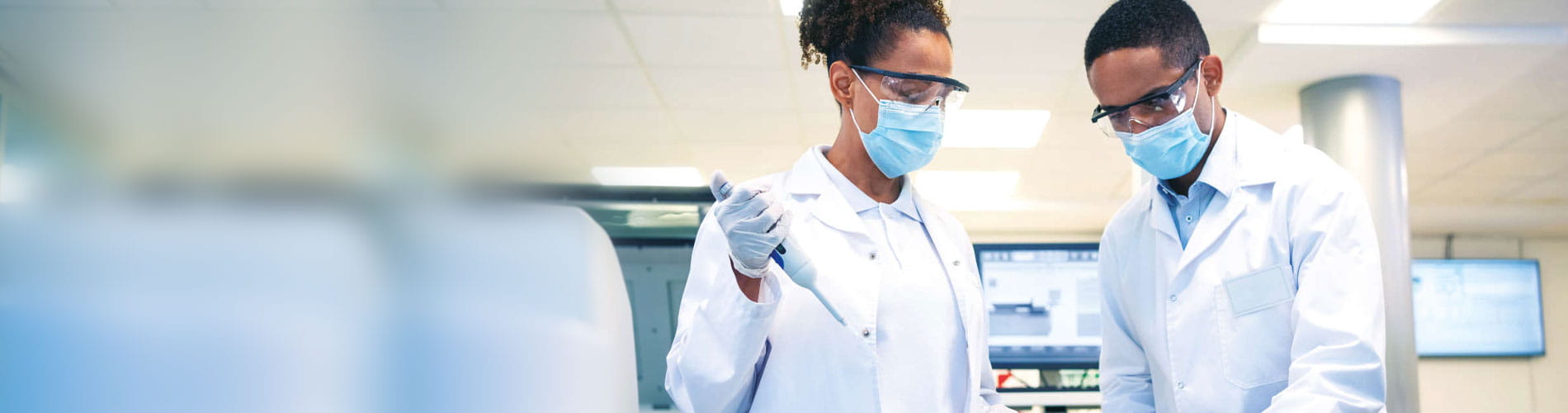 two lab workers in masks
